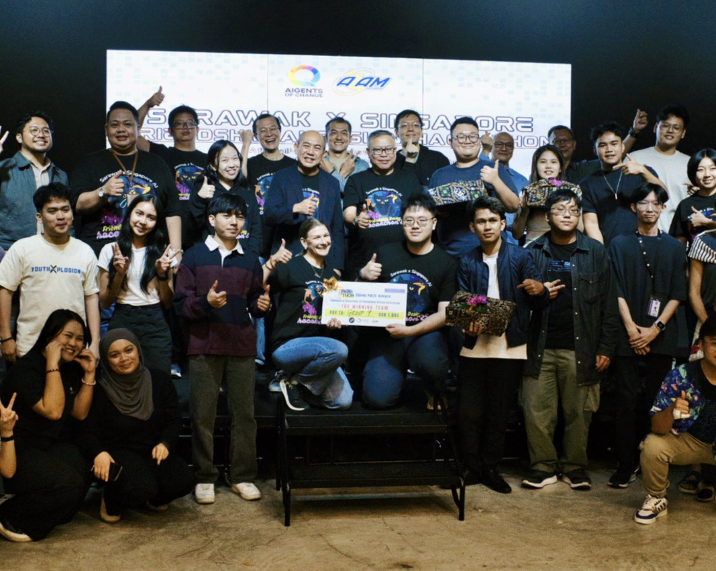 Winning team on stage at the Sarawak × Singapore Friendship Hackathon
